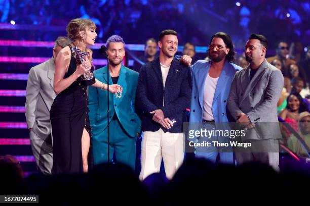 Taylor Swift accepts the Best Pop award for "Anti-Hero" from Joey Fatone, Lance Bass, Justin Timberlake, JC Chasez, and Chris Kirkpatrick of *NSYNC...