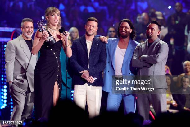 Taylor Swift accepts the Best Pop award for "Anti-Hero" from Joey Fatone, Lance Bass, Justin Timberlake, JC Chasez, and Chris Kirkpatrick of *NSYNC...