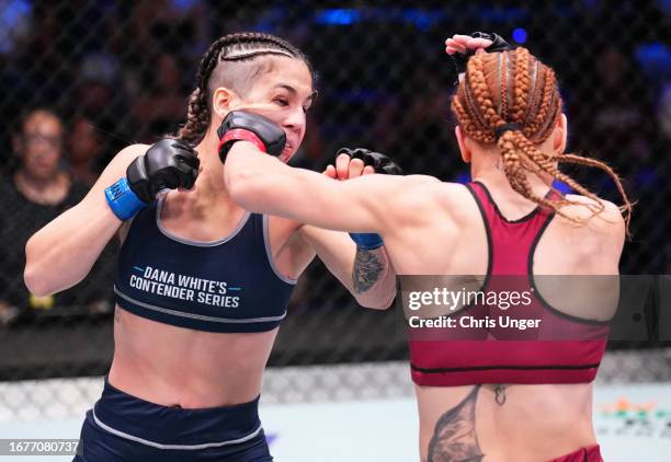 Julia Polastri of Brazil punches Patricia Alujas of Paraguay in a strawweight fight during Dana White's Contender Series season seven, week six at...