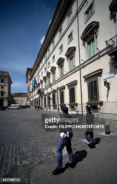 An ambulance leaves the area where a Carabiniere police officer was shot by an apparently disturbed man, on April 28, 2013 in Rome, outside the...