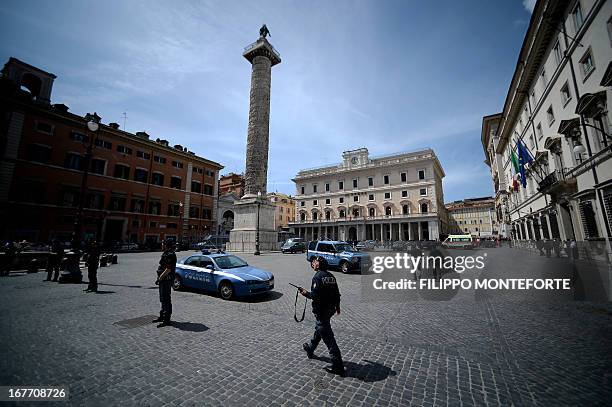 Policemen clear the area where a Carabiniere police officer was shot by an apparently disturbed man, on April 28, 2013 in Rome, outside the palazzo...