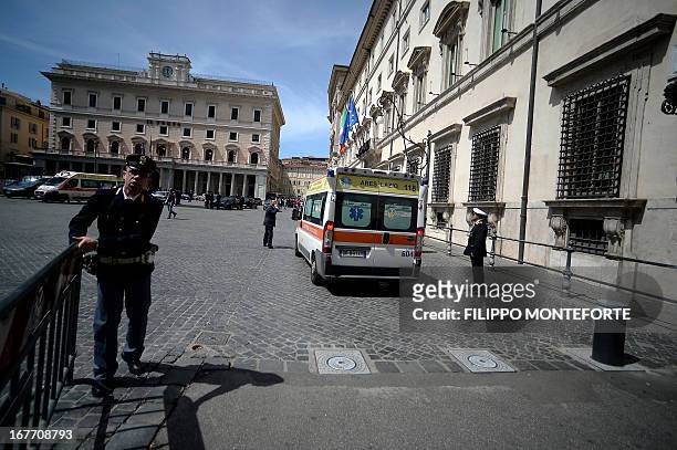 Policemen clear the area where a Carabiniere police officer was shot by an apparently disturbed man, on April 28, 2013 in Rome, outside the palazzo...