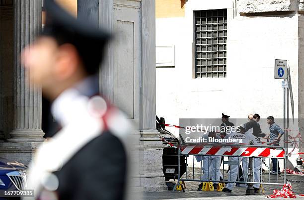 Carabinieri forensics officers look for evidence following a shooting outside the Chigi Palace in Rome, Italy, on Sunday, April 28, 2013. Two Italian...