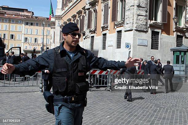 Italian police secure as they patrol around the area where gunshots were fired, in front of the Chigi Premier's office on April 28, 2013 in Rome,...