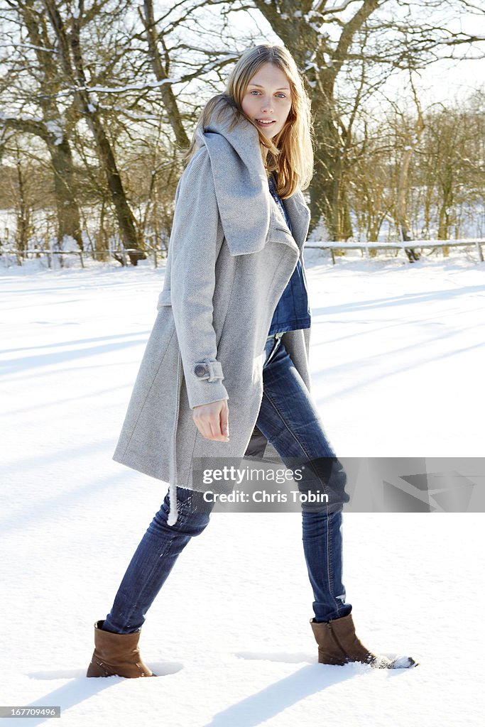 Young woman walking in the snow