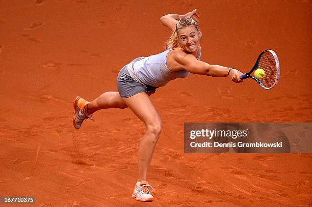 Maria Sharapova of Russia plays a backhand in her final match against Na Li of China during Day 7 of the Porsche Tennis Grand Prix at Porsche-Arena...