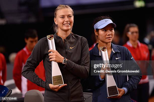 Maria Sharapova of Russia poses with her trophy after winning her final match against Na Li of China during Day 7 of the Porsche Tennis Grand Prix at...
