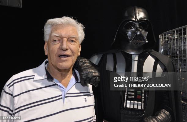 English actor David Prowse , who played the character of Darth Vader in the first Star Wars trilogy poses with a fan dressed up in a Darth Vader...
