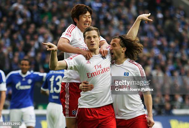 Marcell Jansen of Hamburgcelebrates with his team mates after scoring his team's first goal during the Bundesliga match between FC Schalke 04 and...
