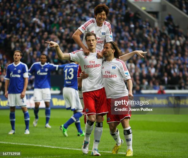 Marcell Jansen of Hamburg celebrates with his team mates after scoring his team's first goal during the Bundesliga match between FC Schalke 04 and...