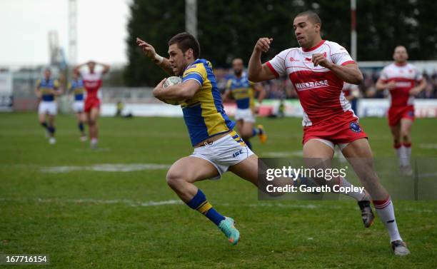 Joel Moon of Leeds dives past Omari Caro of Hull KR to score his second half try during the Super League match between Hull Kingston Rovers and Leeds...