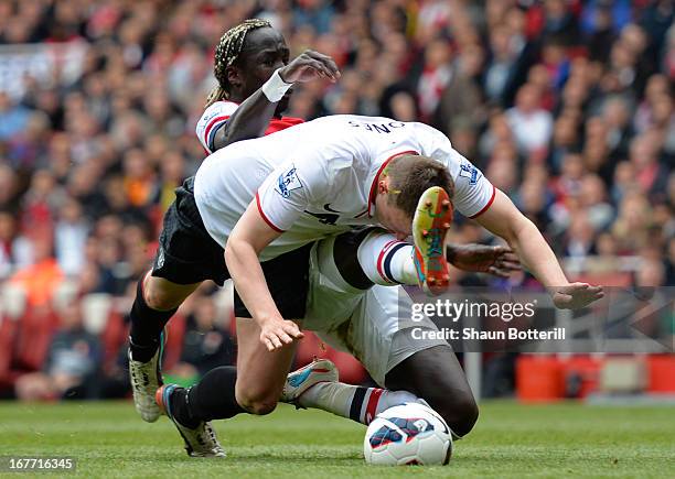 Phil Jones of Manchester United clashes with Bacary Sagna of Arsenal during the Barclays Premier League match between Arsenal and Manchester United...