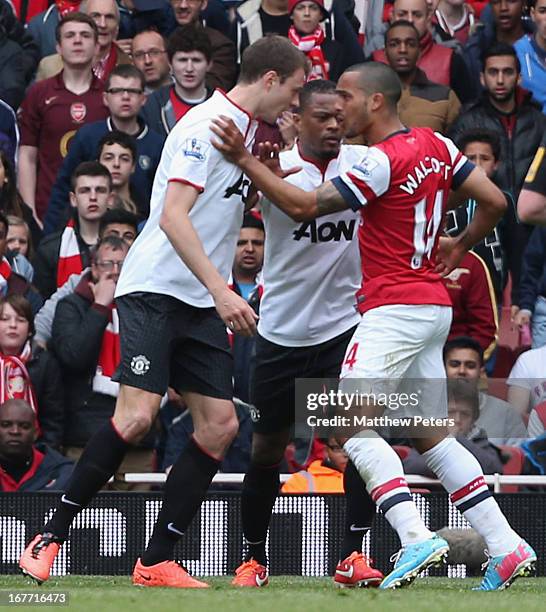 Jonny Evans of Manchester United clashes with Theo Walcott of Arsenal during the Barclays Premier League match between Arsenal and Manchester United...