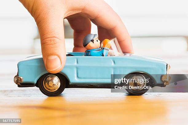 hand pushing vintage blue toy convertible car - kid playing car imagens e fotografias de stock