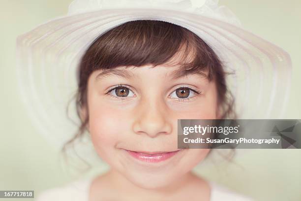 portrait of happy little girl in white hat - young girl white background stock pictures, royalty-free photos & images