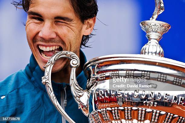 Rafael Nadal of Spain bites the trophy after winning his final match againts Nicolas Almagro of Spain during day seven of the 2013 Barcelona Open...