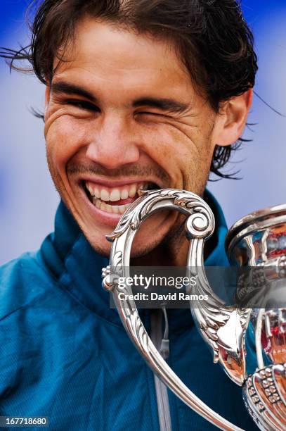 Rafael Nadal of Spain bites the trophy after winning his final match againts Nicolas Almagro of Spain during day seven of the 2013 Barcelona Open...