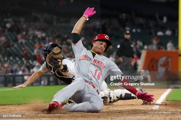 Noelvi Marte of the Cincinnati Reds slides past the tag by Jake Rogers of the Detroit Tigers for the go ahead run in the 10th inning at Comerica Park...