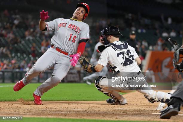 Noelvi Marte of the Cincinnati Reds slides past the tag by Jake Rogers of the Detroit Tigers for the go ahead run in the 10th inning at Comerica Park...