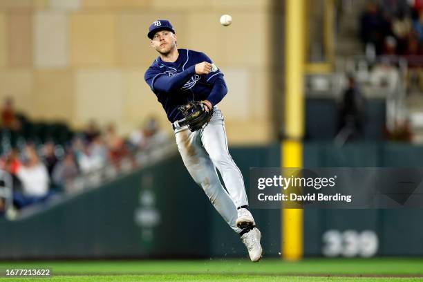 Taylor Walls of the Tampa Bay Rays throws the ball to first base to get out Kyle Farmer of the Minnesota Twins in the seventh inning at Target Field...