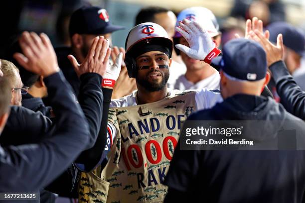 Willi Castro of the Minnesota Twins celebrates his two-run home run with teammates in the dugout in the seventh inning of the game against the Tampa...