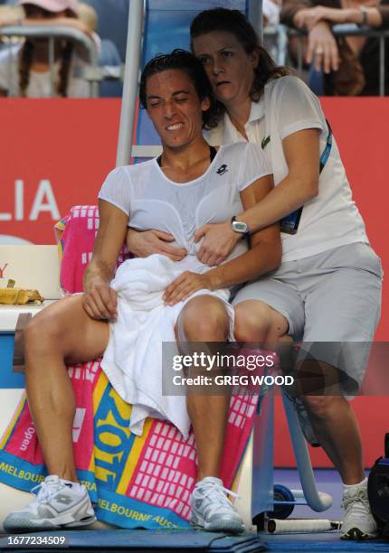 Francesca Schiavone of Italy receives the physios attenion to midriff in a break between points against Svetlanda Kuznetsova of Russia during their...