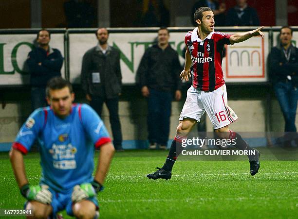 Milan's French midfielder Mathieu Flamini celebrates after scoring during the Italian Serie A football match between AC Milan and Catania on April...