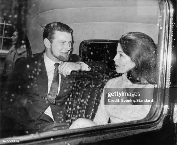 English former model and showgirl Christine Keeler with her friend, journalist and racing driver Paul Mann, on their way to Marylebone Court, where...