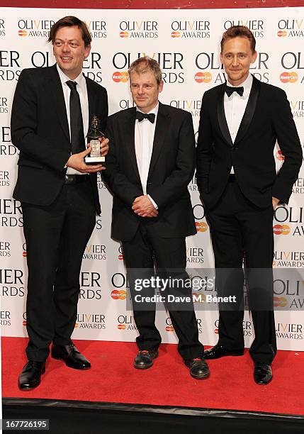 Simon Stephens, Mark Haddon and Tom Hiddleston pose in the press room with the Mastercard Best New Play award at The Laurence Olivier Awards 2013 at...