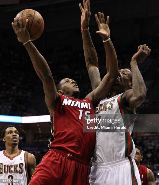 Miami Heat point guard Mario Chalmers drives to the basket against Milwaukee Bucks center Larry Sanders during first-quarter action in Game 4 of the...