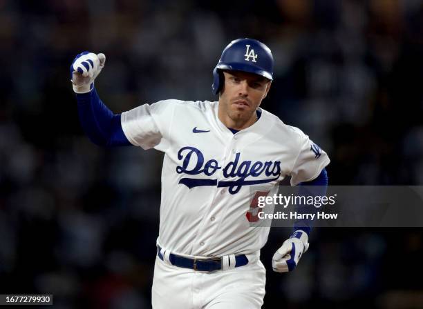 Freddie Freeman of the Los Angeles Dodgers reacts to his two run home run, to take a 3-0 lead over the San Diego Padres, during the third inning at...