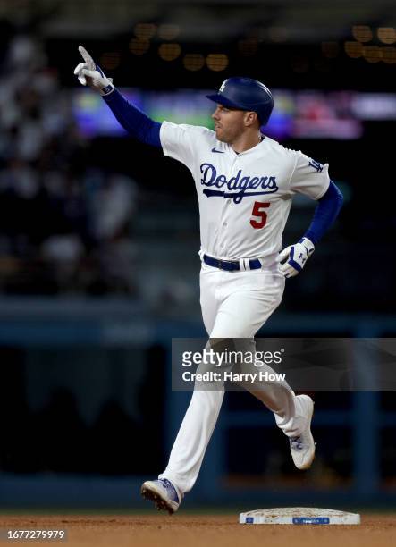 Freddie Freeman of the Los Angeles Dodgers reacts to his two run home run, to take a 3-0 lead over the San Diego Padres, during the third inning at...