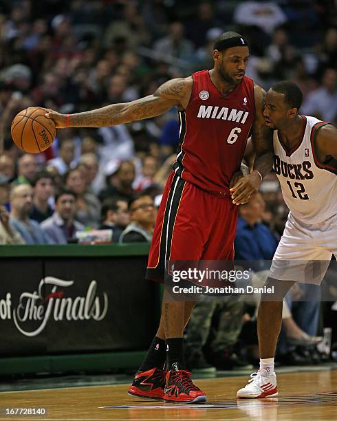 LeBron James of the Miami Heat readies to move against Luc Richard Mbah a Moute of the Milwaukee Bucks in Game Four of the Eastern Conference...