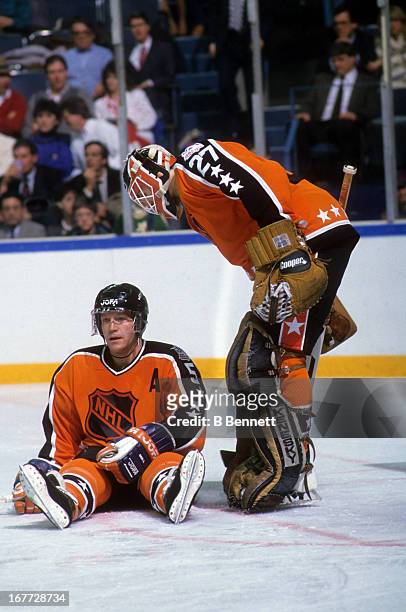 Goalie Ron Hextall of the Wales Conference and the Philadelphia Flyers talks to Denis Potvin of the Wales Conference and the New York Islanders...