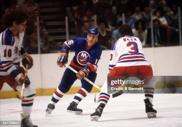 Mike McEwen of the New York Islanders is defended by Barry Beck of the New York Rangers during an 1981 Stanley Cup Semi Finals game in May, 1981 at...