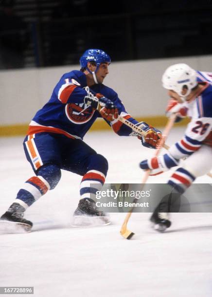 Mike McEwen of the New York Islanders looks to pass during an NHL preseason game against the New York Rangers in October, 1981 at the Madison Square...