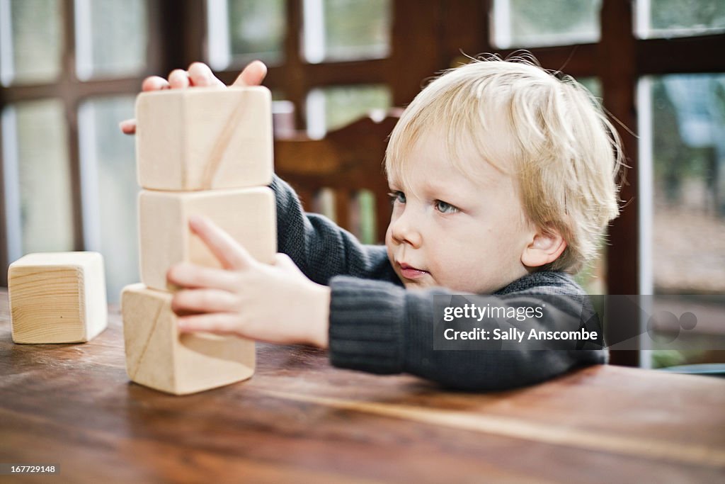 Child playing with wooden blocks