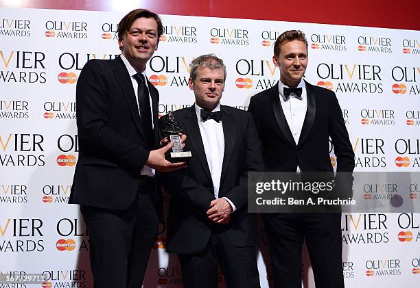 Simon Stephens and Mark Haddon with their Best New Play award with presenter Tom Hiddleston during The Laurence Olivier Awards at the Royal Opera...