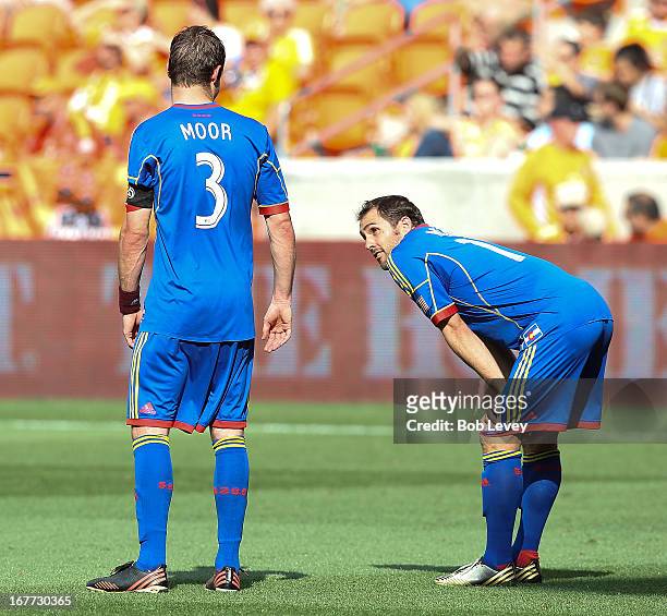 Drew Moor of the Colorado Rapids and Brian Mullan of the Colorado Rapids talk during a break in the action at BBVA Compass Stadium on April 28, 2013...