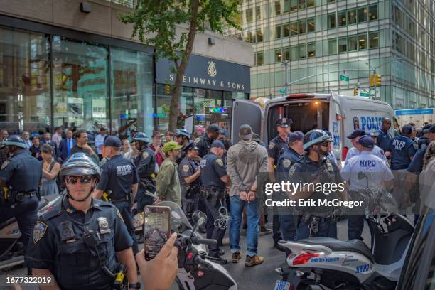 Climate activists seen being arrested by NYPD for blocking the entrance to Bank Of America Tower. Ahead of the Climate Ambition Summit in New York...