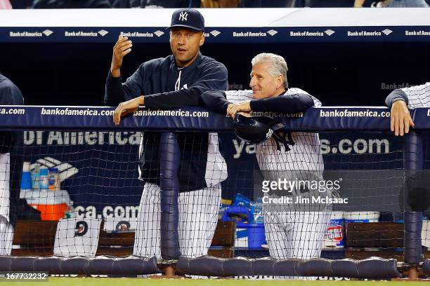Derek Jeter and first base coach Mick Kelleher of the New York Yankees look on against the Toronto Blue Jays at Yankee Stadium on April 25, 2013 in...