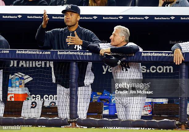 Derek Jeter and first base coach Mick Kelleher of the New York Yankees look on against the Toronto Blue Jays at Yankee Stadium on April 25, 2013 in...