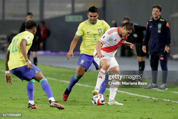 Aldo Corzo of Peru competes for the ball with Casemiro of Brazil during a FIFA World Cup 2026 Qualifier match between Peru and Brazil at Estadio...