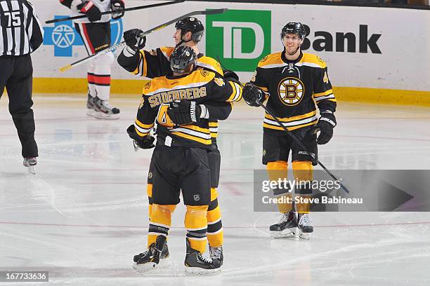 Zdeno Chara, Dennis Seidenberg and David Krjeci of the Boston Bruins celebrate a goal against the Ottawa Senators at the TD Garden on April 28, 2013...