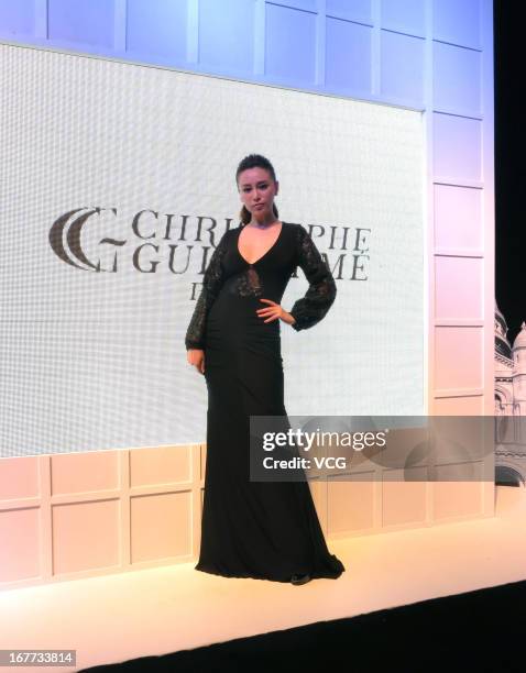 Model showcases designs on the catwalk during the Parisian designer Christophe Guillarme fashion show at INTIME Mall on April 13, 2013 in Hangzhou,...