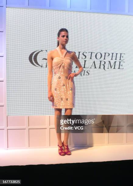 Model showcases designs on the catwalk during the Parisian designer Christophe Guillarme fashion show at INTIME Mall on April 13, 2013 in Hangzhou,...