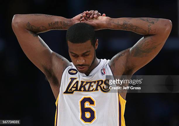 Earl Clark of the Los Angeles Lakers walks back to the bench during a timeout in the first half against the San Antonio Spurs during Game Four of the...