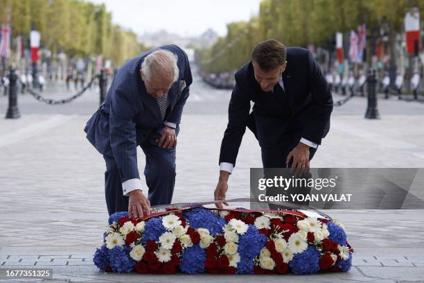 Britain's King Charles III and French President Emmanuel Macron lay a wreath of remembrance at the Tomb of the Unknown Soldier during an official...