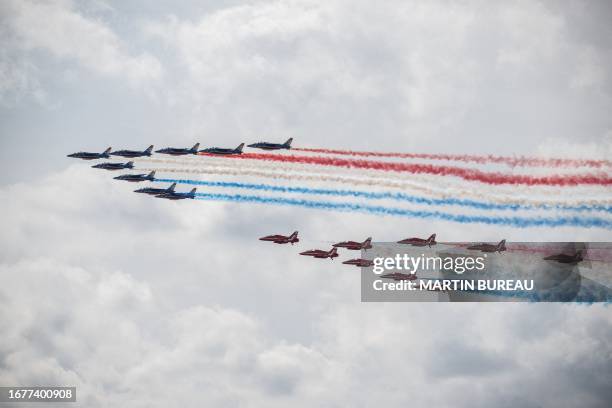 France's Air Force elite acrobatic flying team "Patrouille de France" and Britain's Royal Air Force's acrobatic team the "Red Arrows" perform a fly...
