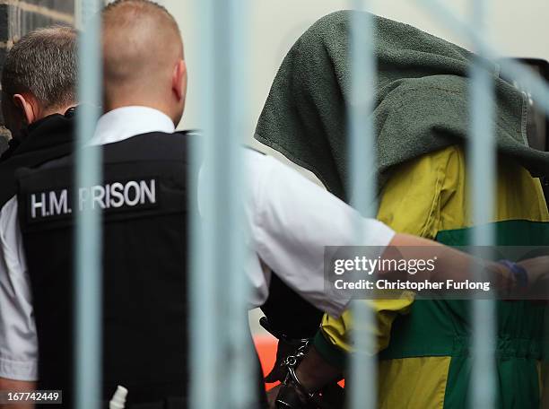 Mark Bridger arrives at Mold Crown Court covered with a blanket, for the first day of his trial accused of the murder of April Jones, on April 29,...